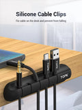 Silicone Cable Clips on a desk organize a phone charger, USB-C, and two USB-A connectors labeled TOPK for a tidy setup.